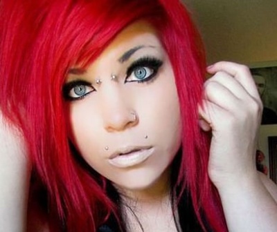  Piercing bridge sur femme aux cheveux rouges avec cheek et piercing narine 