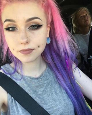  Piercing cheek, joue, fossette sur femme aux cheveux roses et lilas 